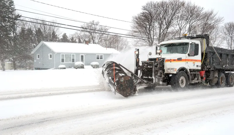 A Department operated snowplow clearing snow off of a roadway.
