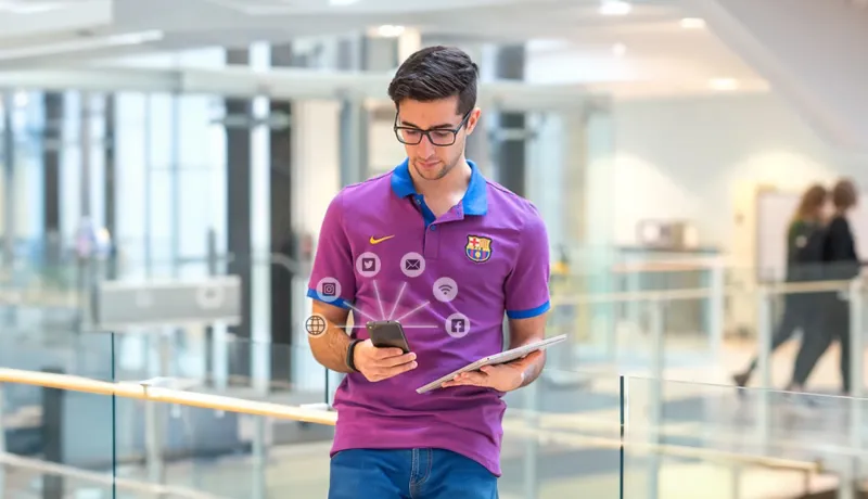 Man holding cell phone with social icons