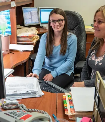 Two women looking at a computer
