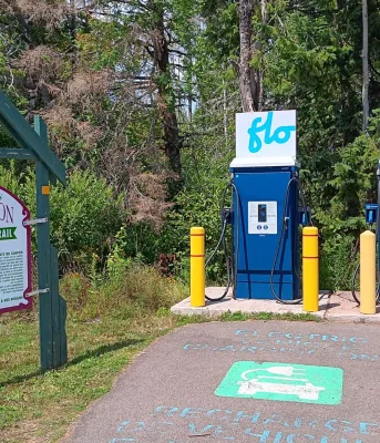 Two EV charging stations beside a Confederation Trail sign.