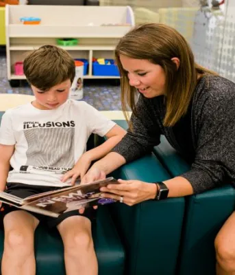 Woman reading book to child