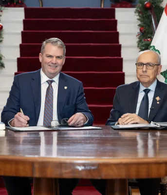 The new Premier and the Lieutenant Governor of PEI sit together at a table.