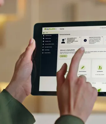 A woman uses MyHealthPEI on an ipad.