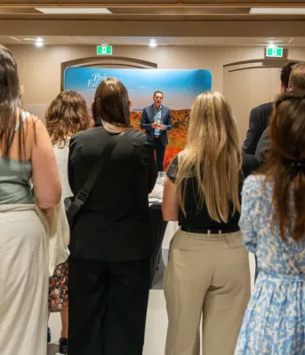 A group of med students gather around Premier Rob Lantz while he speaks.