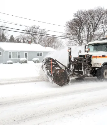 A Department operated snowplow clearing snow off of a roadway.