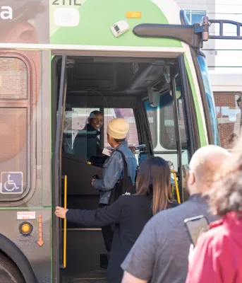 People boarding a public transit bus.
