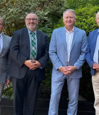 The four Atlantic Transportation Ministers stand next to each other outside.