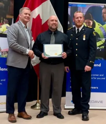 Three white men stand next to each other posing for a photo.
