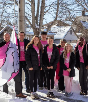 Adults and children wear pink shirts for anti-bullying.