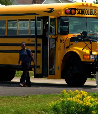 Children getting off a school bus