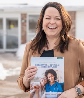 Minister of Finance Jill Burridge holding a copy of the Provincial Operating Budget