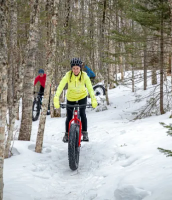 Trio of persons riding fat bikes on trail at Bonshaw Provincial Park in winter