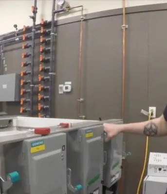 Employee monitors equipment at Aspin Kemp