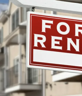 For Rent sign in front of Apartment Buildings