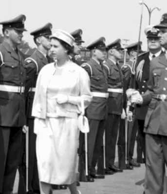 Queen Elizabeth II inspecting a lineup of military personnel at the Charlottetown waterfront during the Royal Visit to Prince Edward Island in 1959.