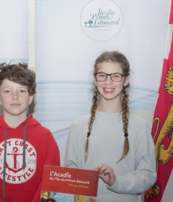 Linda Lowther (left) and Georges Arsenault, co-authors of the book L’Acadie de l Île-du-Prince-Édouard: 300 ans d’histoire, stand with students from École St-Augustin at the book's recent launch 