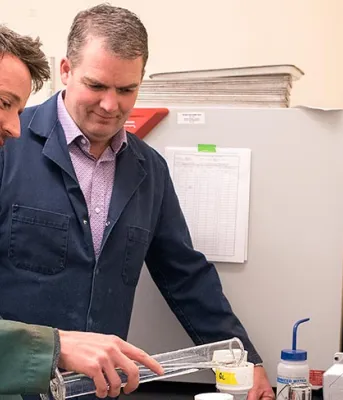 Two people looking at lab equipment