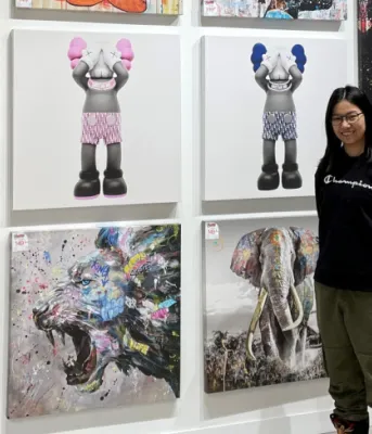 image of a person standing in front of artwork images