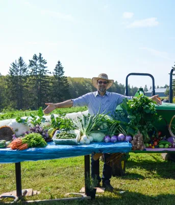 Farmer with display of produce