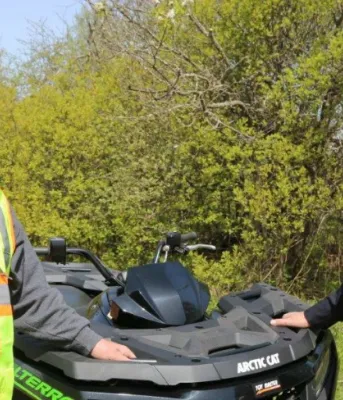 PEI ATV Federation president Peter Mellish and Conservation Officer Wade MacKinnon  stand outside beside an All Terrain Vehicle