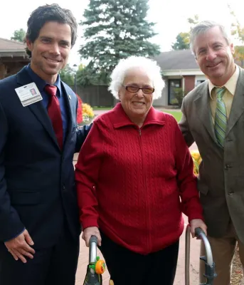 Minister Robert Henderson and two others standing in front of Beach Grove Home
