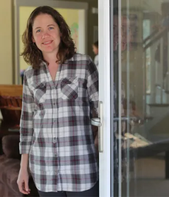 Beth Peters at her passive solar house in Long River