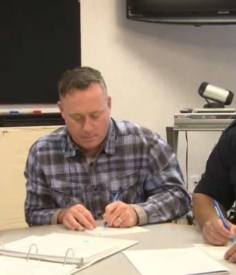 Three people sitting at a table