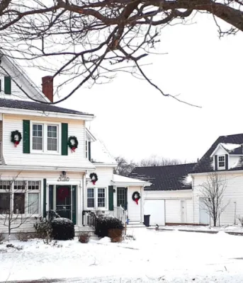A winter photo of the Callbeck House and barn in Bedeque