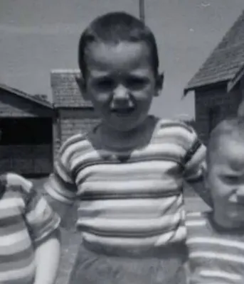 Carter Jeffrey stands in the middle of two of his brothers in a photo taken when they were children.