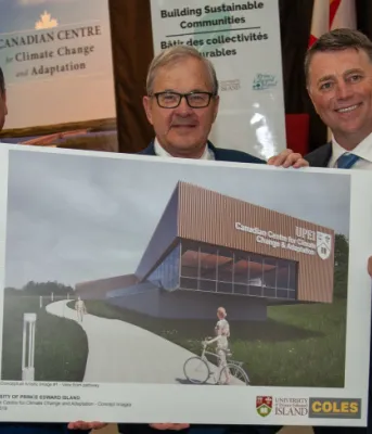 UPEI president Abd-El-Aziz, PEI Premier KIng and MP MacAulay stand holding an artists rendition of the new research centrer