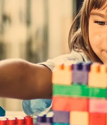 image of child playing with building blocks