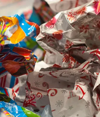 A photo colourful wrapping paper sticking out of the top of a gift bag.