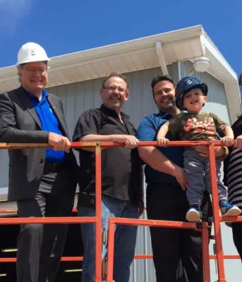 Five people on a raised platform