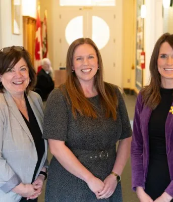 image of three people standing in a room