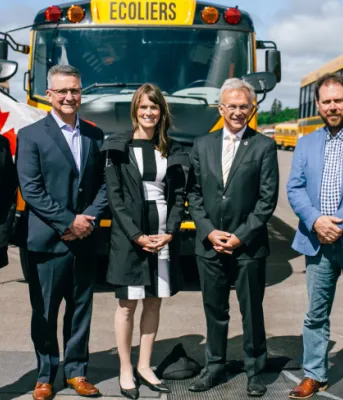 image of people standing in front of electric buses
