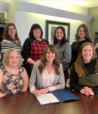 image of a group of people gathered around a table