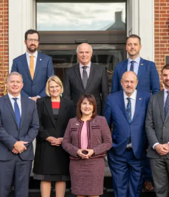 image de personnes debout dans les escaliers devant un hôtel.