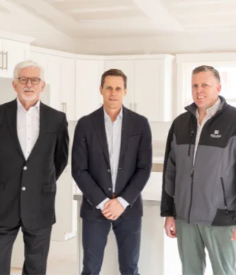 image of three people standing in a kitchen of a new apartment