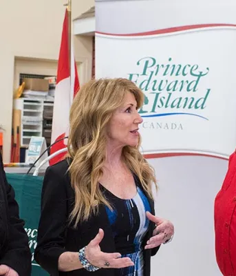 Officials in front of Government banner for housing announcement