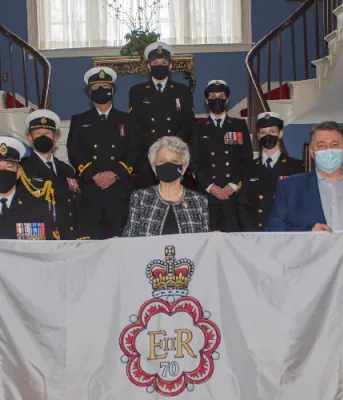 image of a group of people on stairs holding a flag
