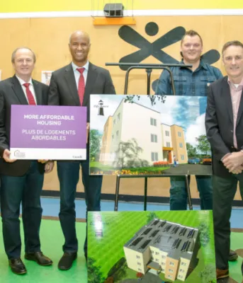 image of a group of people with building sketches in front of them