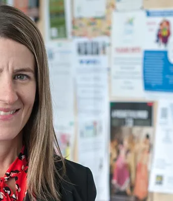 Worker Advisor Maureen Peters stands outside in front of a building