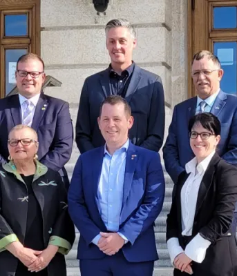image of people standing on steps leading to a building