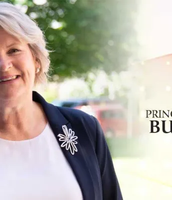 Finance Minister Darlene Compton stands holding a copy of the 2019 - 2020 operating budget