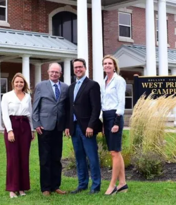 Image of officials in front of main building of Holland College, West Prince campus 
