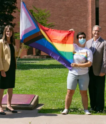 image of people raising a flag