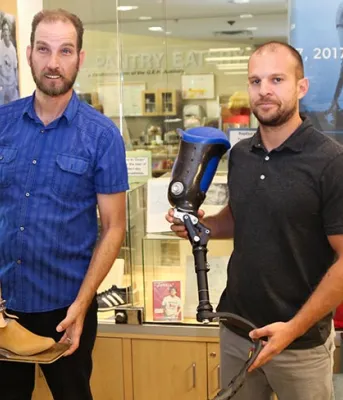 QEH prosthetic technicians Paul Hoar and Gabe Arsenault display prosthetic legs