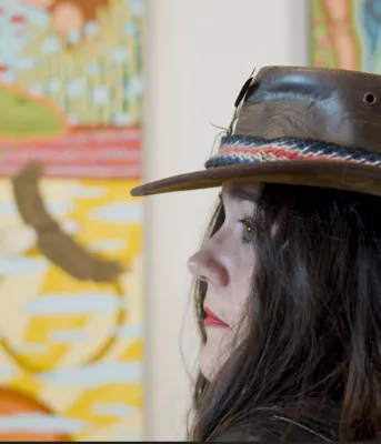 Artist's profile in front of her painting