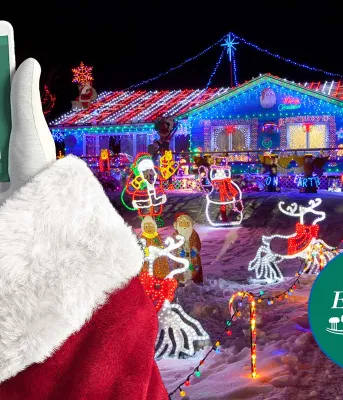 image of Santa holding his cellphone with a confirmed VaxPass message on it