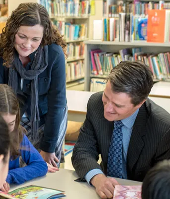 Photo shows Minister Jordan Brown with staff and students at West Royalty Elementary